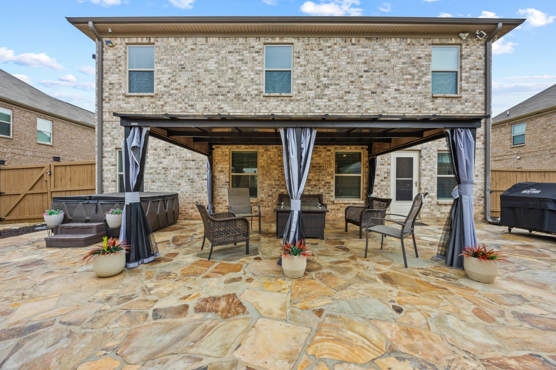 Covered patio with hot tub and lounge